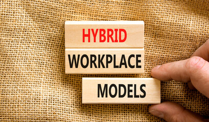 Hybrid workplace models symbol. Concept words Hybrid workplace models on wooden blocks. Businessman hand. Beautiful canvas background. Business hybrid workplace models quote concept. Copy space - obrazy, fototapety, plakaty