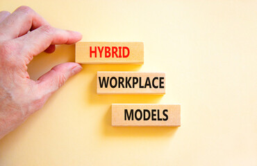 Hybrid workplace models symbol. Concept words Hybrid workplace models on wooden blocks. Businessman...