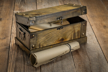 retro decorative case or storage box with rolls of antique paper against rustic wood