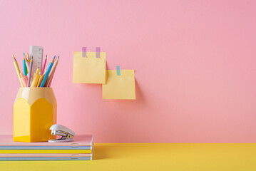 Back to school concept. Photo of school supplies on yellow desk pencil holder mini stapler stack of...