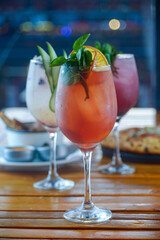 three cocktails on a table