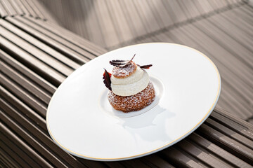 tasty cake with vanilla cream on white plate