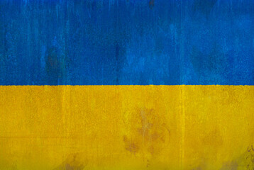 Full frame front view photo of a weathered flag of Ukraine painted on a rusty, grunge and dirty...