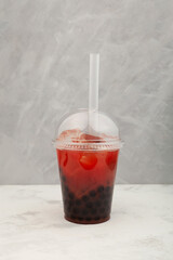 Watermelon boba drink or fruits bubble tea in disposable plastic take away cup. Refreshing ...