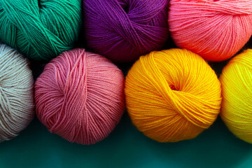 Background of stacked skeins of acrylic yarn. Textile industry. Arranged balls  of yarn. Natural...