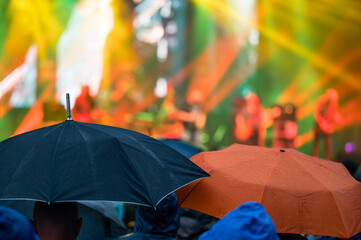 Umbrellas during a music concert in the rain