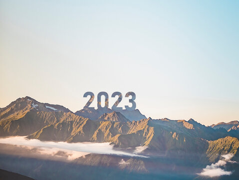number 2023 on the mountain peak, happy new year, success and freedom concept
