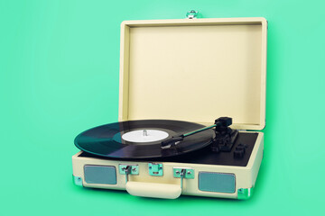 Vintage vinyl record player isolated on green background