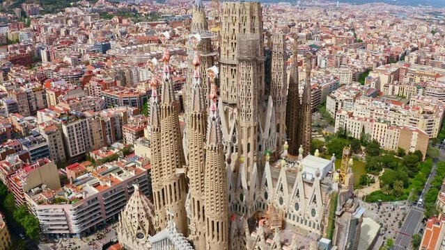 Top aerial view flying drone shot over unfinished monumental holy place catholic religions god building historical architectural of Spanish city Barcelona facade of church La Sagrada Familia cathedral
