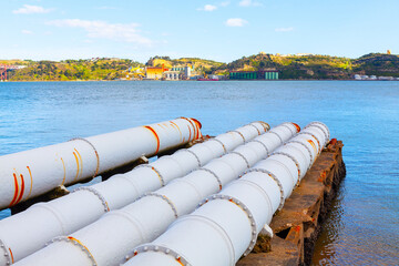 Large pipes in the river water . Pipes water supply of Lisbon city . Tagus river coastline