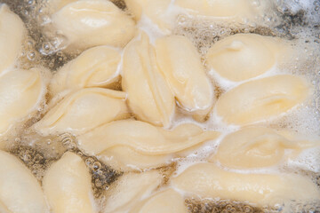 Top view of dumplings boiling
