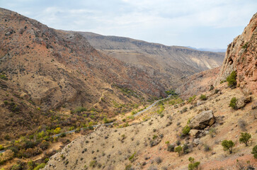 Picturesque view of road leading though gorge between rocks to Noravank monastery complex, Armenia