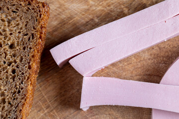 sliced boiled sausage on a wooden board