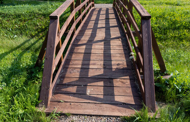 details of an old wooden bridge over a small river