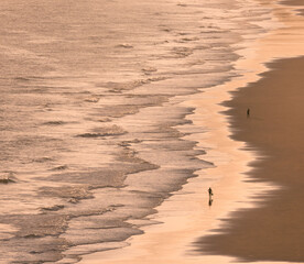 silhouette of a persons walking on the beach
