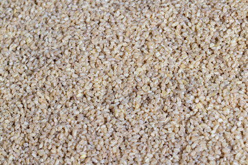 Fresh uncooked bulgur porridge on the table