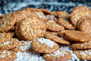 oatmeal thin round cookies with lots of sesame seeds