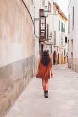 Happy cute girl, Palma, Mallorca (Majorca) Cinema effect. Vintage. Beautiful kind smile. Cinematic Film-Like. Attractive brunette with curly hair woman. Cute charming girl, Spain, Mallorca. 