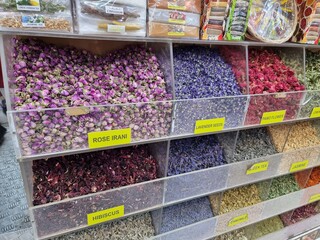 Various dried Blended dry leaf tea with aromatic flowers, including rose irani, lavender, hibiscus, pamo flower, jasmine, green tea, lemon grass, camomile and sunflower in a street shop of middle east