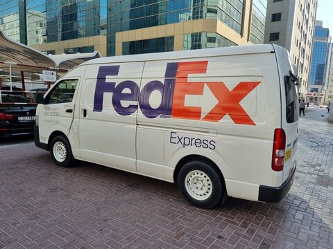 FedEx express Toyota hiace van delivering in streets of Dubai, FedEx is famous leading American multinational courier delivery services company. United Arab Emirates - November 23, 2021