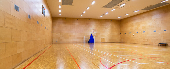 Empty sports hall for playing basketball court view from the corner
