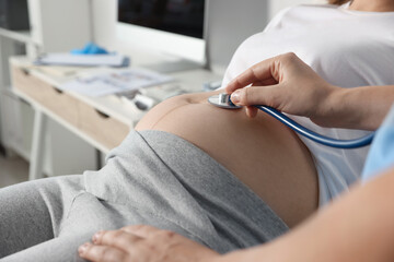Fototapeta premium Doctor examining pregnant woman in hospital, closeup