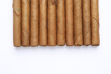 Many expensive cigars on white background, top view