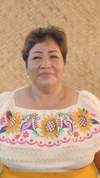 Indigenous Mexican woman looks directly into the camera. 