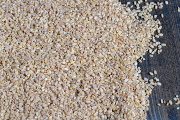 Fresh uncooked bulgur porridge on the table