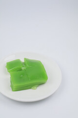 Steamed Layer sweet cake or Khanom Chan Thai traditional dessert (Green Pandan flavour) on white background. Famous desserts in Thailand.