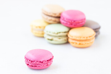 Close up of  pink  macarons on the white  table background.