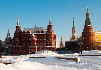 View of State Historical Museum and Kremlin towers from Manezhnaya Square on sunny winter day,...