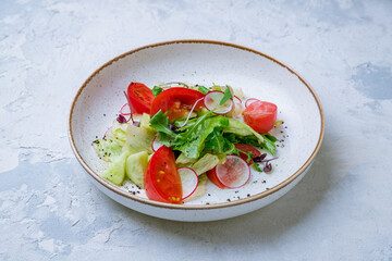 Vegetable salad with tomatoes and cucumbers on plate