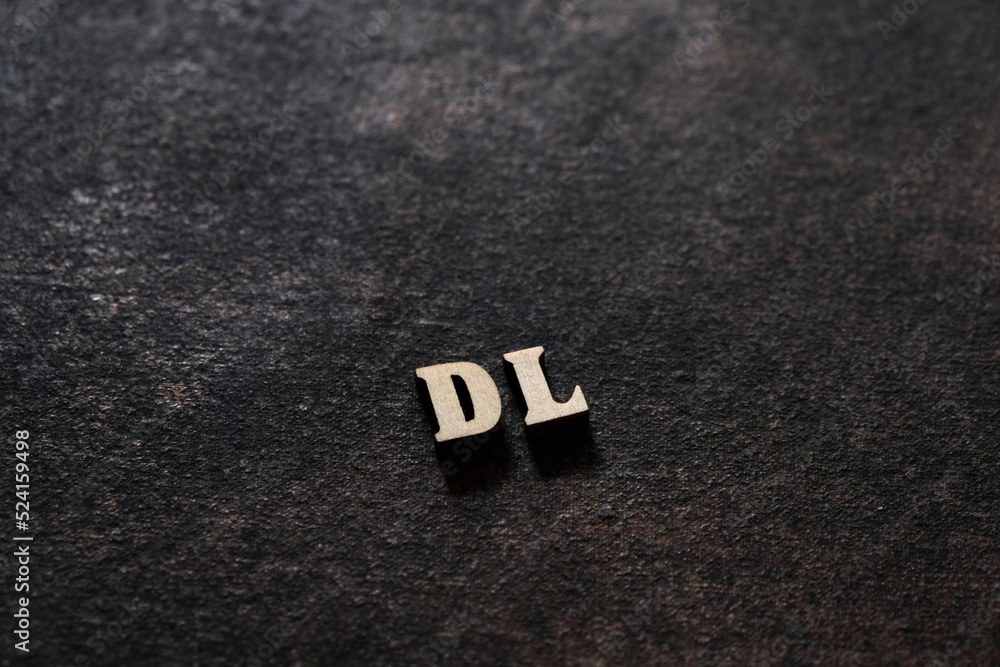 Fototapete the letters d and l above the dark field. initials dl