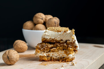 a piece of cake with buttercream and walnuts