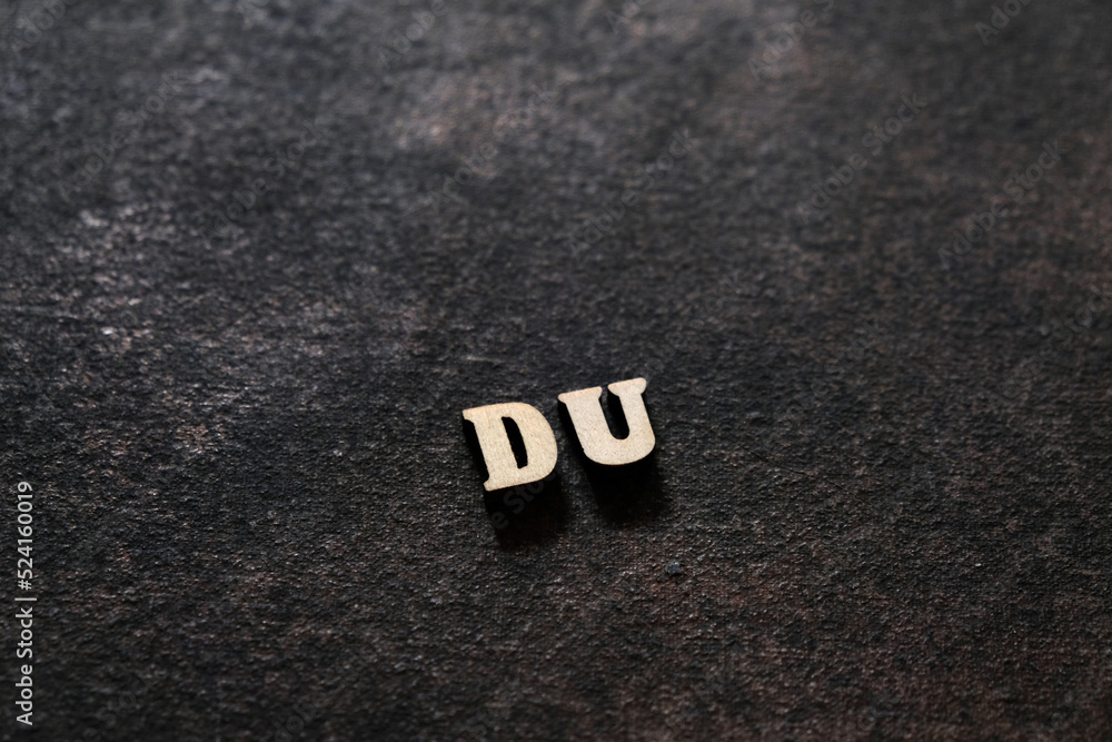 Poster the letters d and u above the dark field. initials du