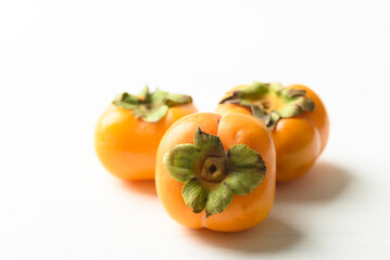 Ripe persimmon fruit on white background