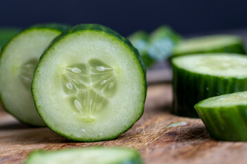 Sliced green cucumber while cooking salad