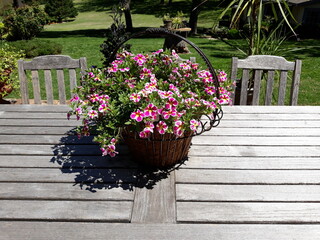 Fototapeta na wymiar Basket of Flowers on a Wooden Table