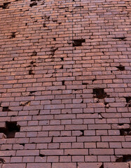 An old brick wall with various damages