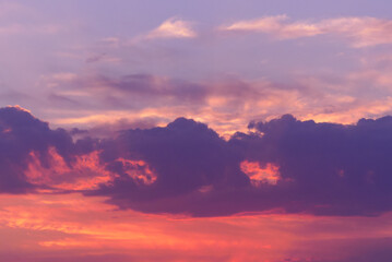 Pink cumulonimbus in the sky at sunset or sunrise. beautiful colorful clouds