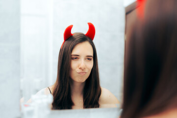 Mean Woman with Devil Horns Looking in the Mirror. Evil narcissistic person checking herself with infatuation and arrogance
 - obrazy, fototapety, plakaty