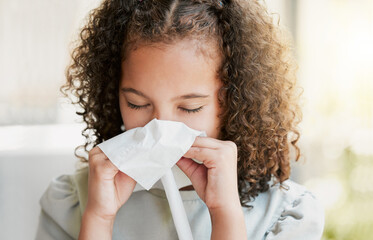 Sick, cleaning nose with tissue and tired girl kid suffering from flu virus, cold or covid at home....