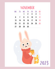 November 2023 calendar. Cute cozy rabbit in sweater and knitted socks with cup of hot tea. Vector illustration. Vertical Template. Week from Monday In English. 2023 year bunny.