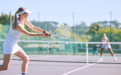 Sports and active tennis player hitting ball with racket equipment during a competitive match or hobby activity on a court. Athletic, sporty and fit woman playing in a tournament game with sportswear - Powered by Adobe