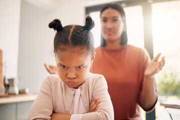 Angry little girl, unhappy and upset after fight or being scolded by mother, frowning with attitude and arms crossed. Naughty child looking offended with stressed single parent in background. - obrazy, fototapety, plakaty