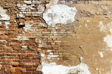 An old brick wall with various damages
