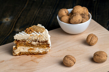 a piece of cake with buttercream and walnuts