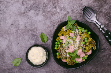 Green pasta with peas, sausages and cheese