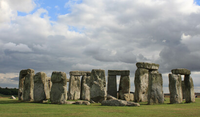 views of stonehenge with clouds and blue sky
